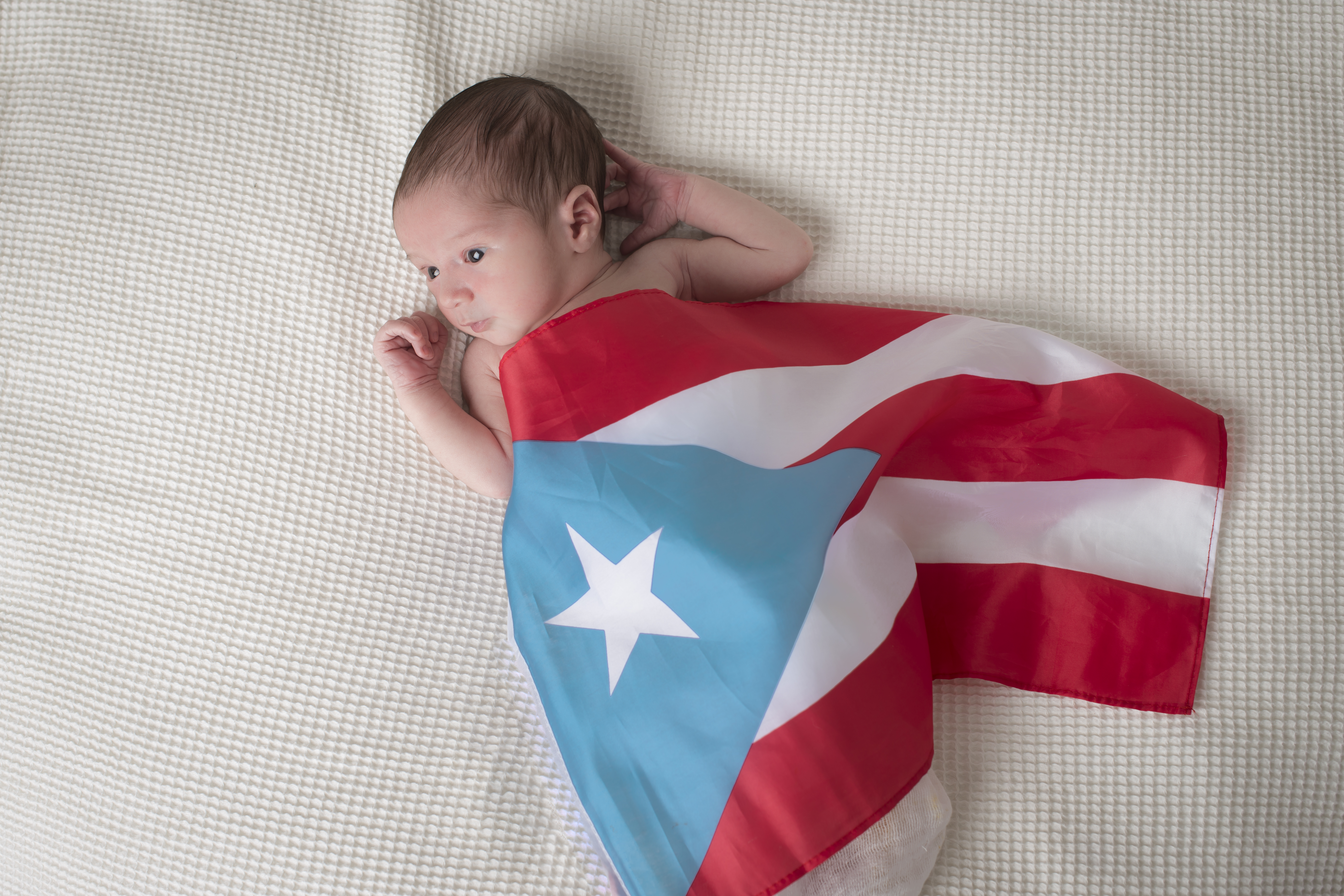 Newborn baby with PR flag