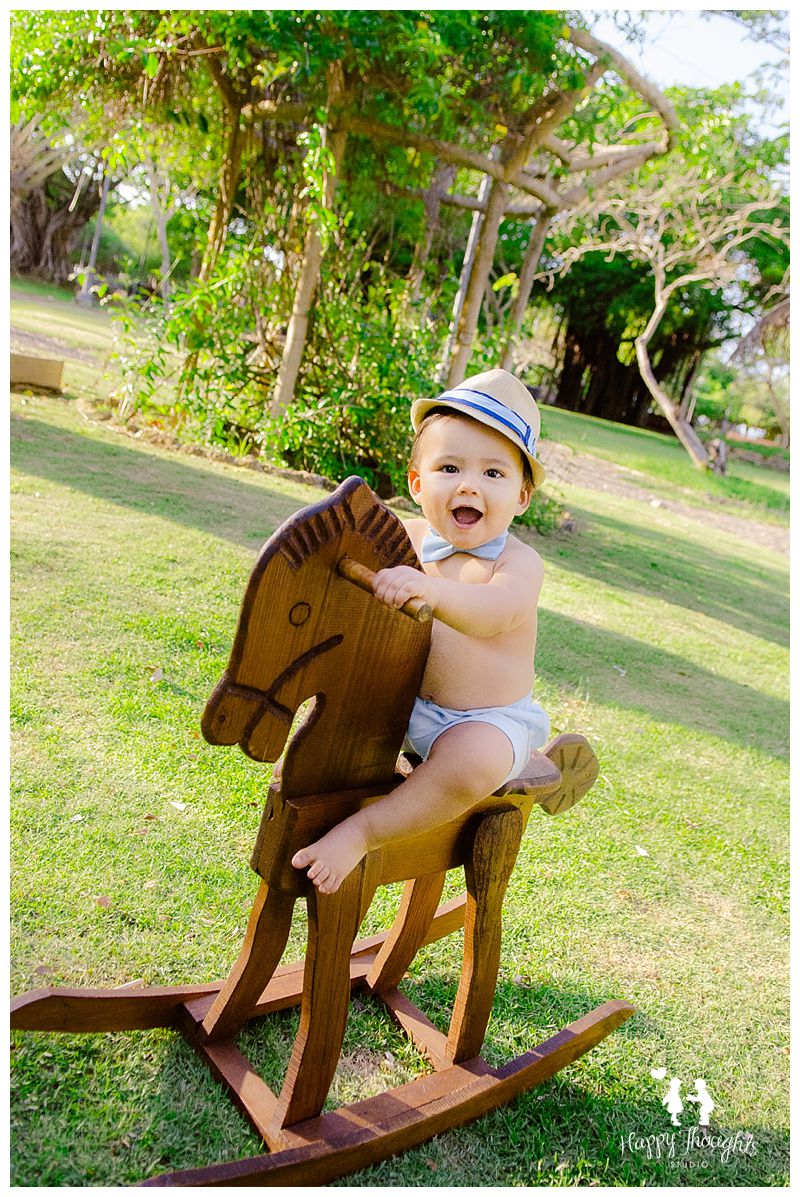 baby boy on wooden rocking horse