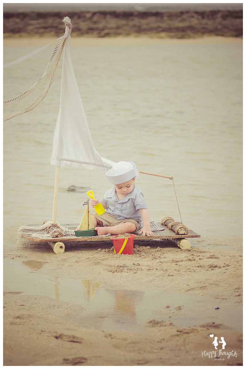 Baby boy on a Vintage Sail-raft boat