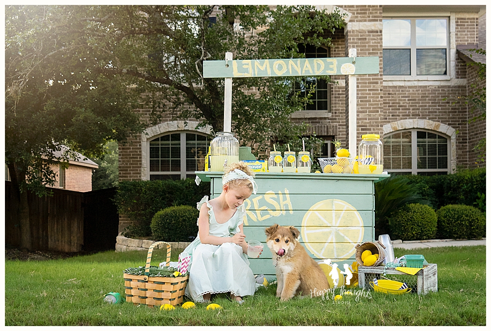 Girls and puppy play lemonade stand